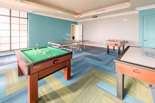 a room with a pool table and two tables at Holiday Inn Club Vacations Sunset Cove Resort, an IHG Hotel in Marco Island