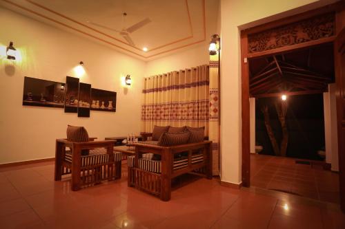 a dining room with a table and chairs and a table and chairsktop at Nimnada Villa in Galle
