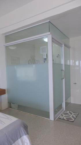 a glass door in a room with a bed at Jelly Sea Resort in Siquijor