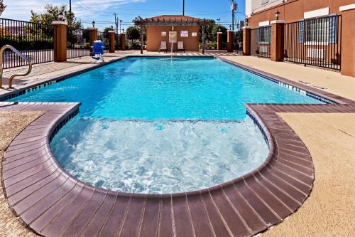 a swimming pool with blue water in a building at Candlewood Suites Baytown by IHG in Baytown