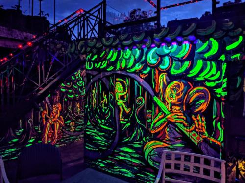 a wall covered in graffiti with neon lights at Hotel Kasauli Regency Stags Not Allowed in Kasauli