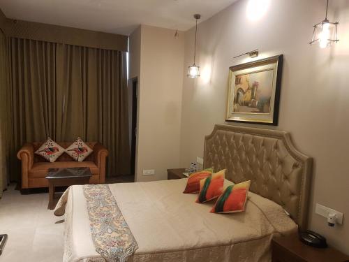 a bedroom with a bed with pillows on it at Hotel Kasauli Regency Stags Not Allowed in Kasauli