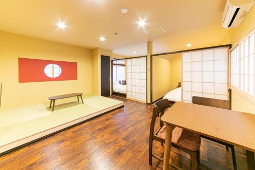 a room with a bed and a table in it at Wa no Kaede in Tokyo