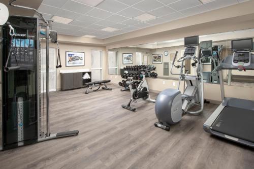 a gym with several treadmills and exercise equipment at Candlewood Suites Alexandria West by IHG in Alexandria