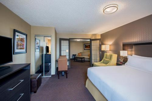 a hotel room with a bed and a living room at Quality Inn & Suites Regina Downtown in Regina
