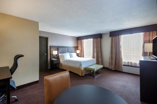 a hotel room with a bed and a table at Quality Inn & Suites Regina Downtown in Regina