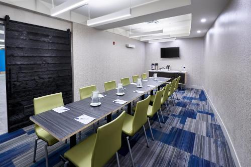 a conference room with a long table and chairs at Holiday Inn Express Hotel & Suites Dieppe Airport by IHG in Moncton