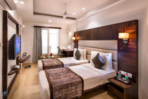 Postel nebo postele na pokoji v ubytování Lords Eco Inn Bengaluru Jayanagar