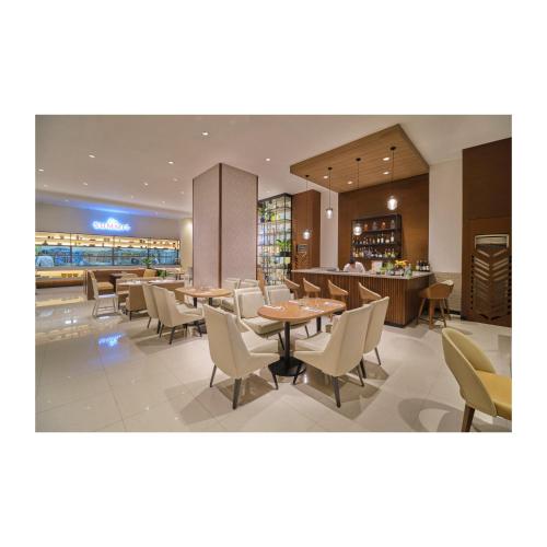 a restaurant with tables and chairs and a bar at Summit Hotel Greenhills in Manila