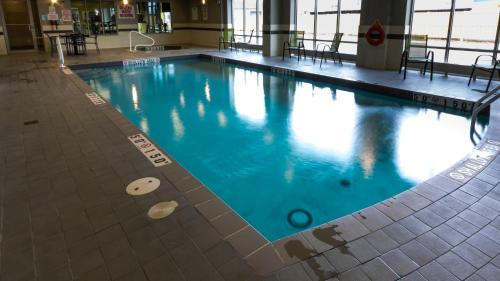a large swimming pool with blue water in a building at Holiday Inn Express Thunder Bay, an IHG Hotel in Thunder Bay