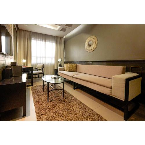 a living room with a couch and a table at Summit Hotel Magnolia in Manila