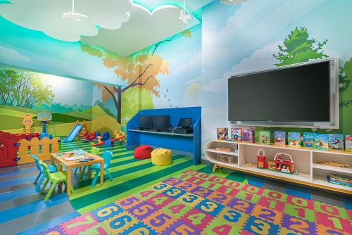 a childs play room with a mural of a tree at Dusit Thani Residence Davao in Davao City