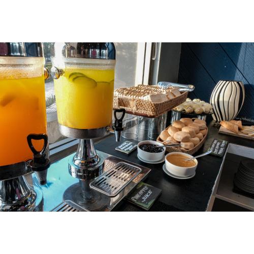 a counter with two glasses of orange juice and pastries at Summit Ridge Tagaytay - Newly Renovated in Tagaytay