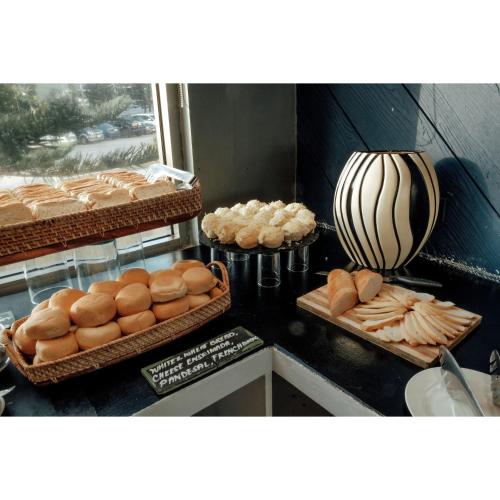 a kitchen with baskets of bread and pastries on a counter at Summit Ridge Tagaytay - Newly Renovated in Tagaytay