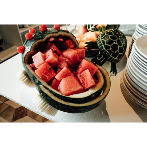 a bowl of watermelon on a table with plates at Summit Ridge Tagaytay - Newly Renovated in Tagaytay