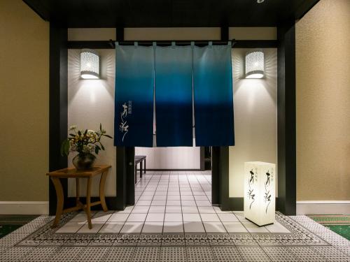 a hallway with a blue curtain and a table at Hotel Nikko Huis Ten Bosch in Sasebo