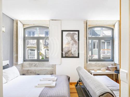a bedroom with two beds and two windows at Almada Apartments 468 in Porto