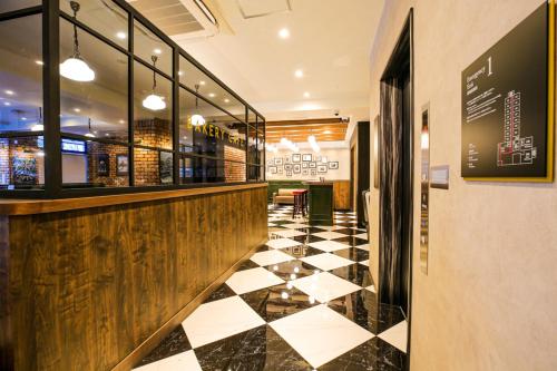 a restaurant with a black and white checkered floor at The Celecton Matsumoto in Matsumoto