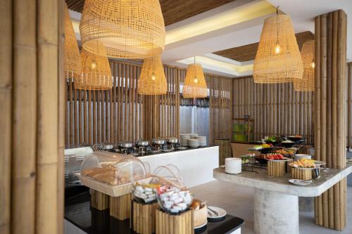 a kitchen with chandeliers and a table with food at VAYNA Boutique Koh Chang in Ko Chang