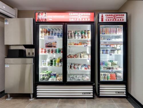 a refrigerator with its doors open in a store at Candlewood Suites Salina by IHG in Salina