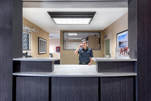 a man talking on a cell phone in a hospital lobby at Candlewood Suites Sterling by IHG in Sterling
