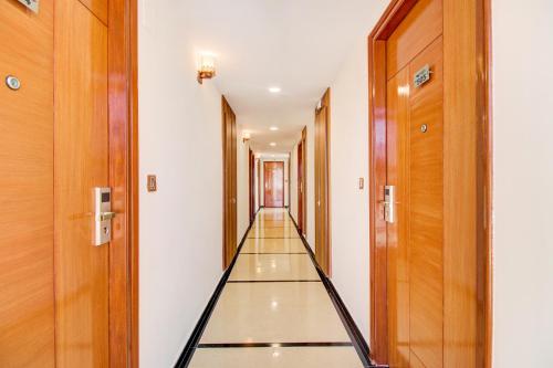 an empty corridor in a building with wooden doors at FabHotel The Royal Suites - Nr Gopalan innovation mall in Bengaluru