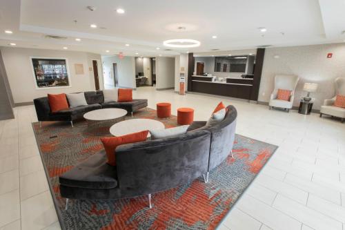 a large living room with couches and a rug at Candlewood Suites - McDonough by IHG in McDonough