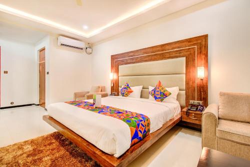a bedroom with a large bed and a couch at FabHotel The Royal Suites - Nr Gopalan innovation mall in Bengaluru