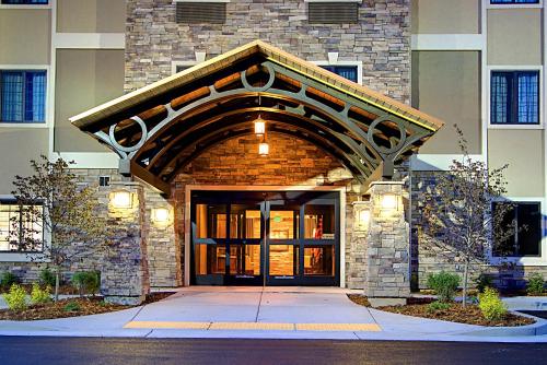 a building with a large entrance to a building at Staybridge Suites Salt Lake-West Valley City by IHG in West Valley City