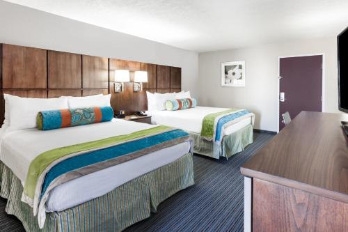 a hotel room with two beds and a desk at Holiday Inn Hotel & Suites Oklahoma City North by IHG in Oklahoma City