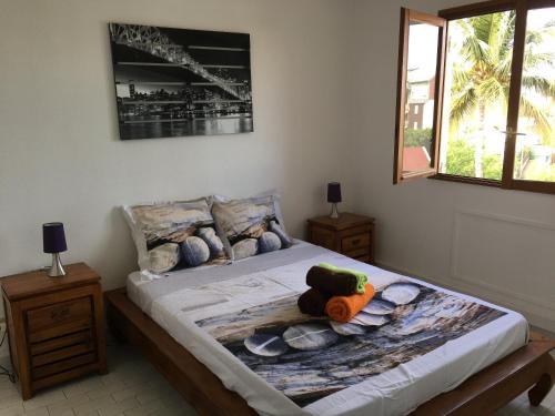 a bedroom with a bed with a stuffed animal on it at CASE BEAOEL in Saint-Gilles les Bains