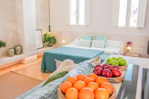 a living room with a bowl of fruit on a table at The Boc Suites in Palma de Mallorca