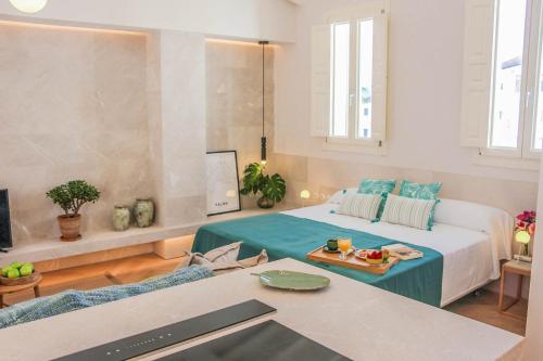 a living room with a bed and a table at The Boc Suites in Palma de Mallorca