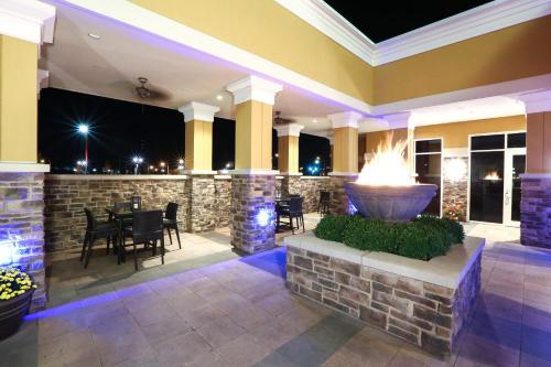 a patio with a fountain in a building at night at Holiday Inn and Suites East Peoria by IHG in Peoria