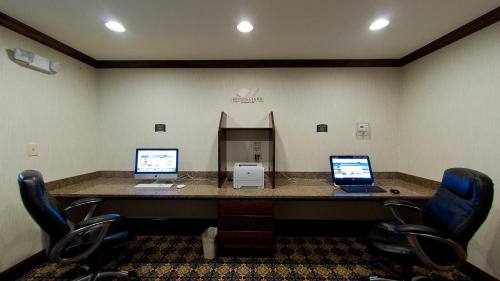 a office with two computers on a desk with chairs at Staybridge Suites East Stroudsburg - Poconos by IHG in East Stroudsburg