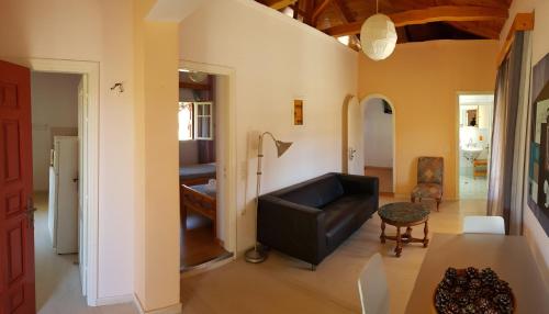 a living room with a couch and a table at Anemona Apartments and Studios in Vasilikos