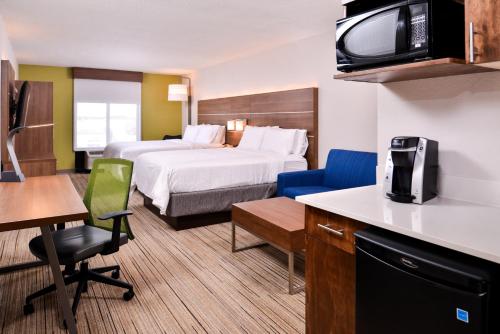 a hotel room with two beds and a tv at Holiday Inn Express Hotel & Suites Tampa-Anderson Road-Veterans Exp by IHG in Tampa