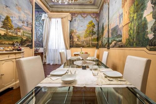 a dining room with a glass table and chairs at Dimora Bandinelli in Florence