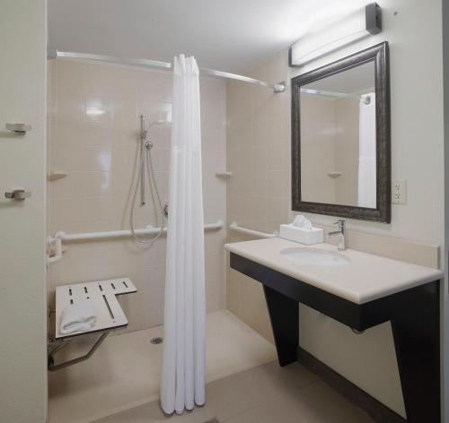 a bathroom with a sink and a shower at Staybridge Suites Fayetteville by IHG in Fayetteville