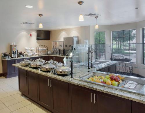 a large kitchen with a counter with fruits on it at Staybridge Suites Fayetteville by IHG in Fayetteville