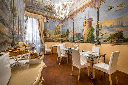 a dining room with a table and chairs and a painting at Dimora Bandinelli in Florence