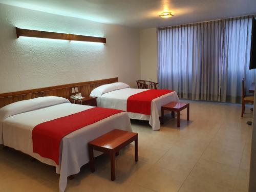 En eller flere senge i et værelse på Hotel Cristal