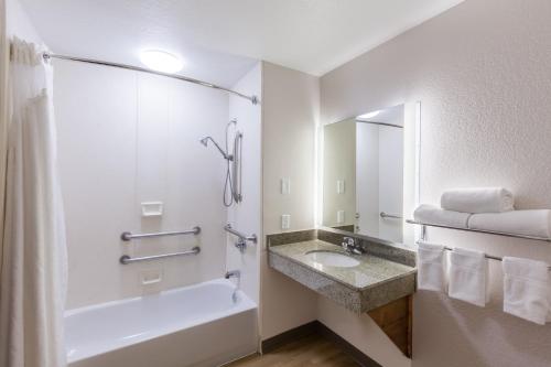 a bathroom with a sink and a tub and a shower at Holiday Inn Express & Suites Tulsa S Broken Arrow Hwy 51 by IHG in Broken Arrow