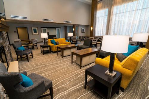 a waiting room with couches and chairs and tables at Staybridge Suites Coeur d'Alene by IHG in Coeur d'Alene