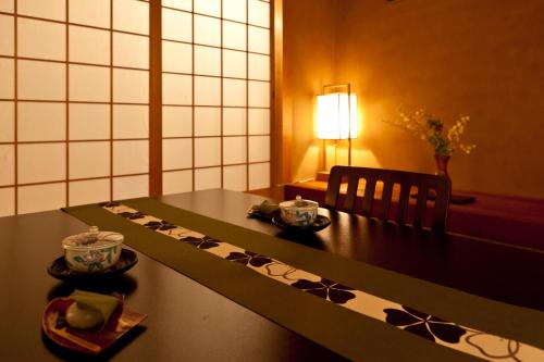 a table with a table cloth on it in a room at Hotel Takasago in Kochi
