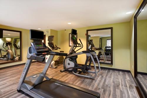 a gym with treadmills and ellipticals and mirrors at Staybridge Suites Grand Rapids-Kentwood by IHG in Grand Rapids