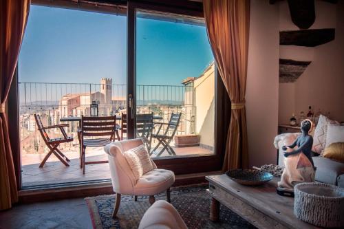 a living room with a large window with a view of the city at La Terrazza sul Duomo in Siena