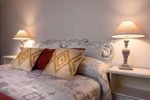a bedroom with a bed with two lamps on it at La Terrazza sul Duomo in Siena