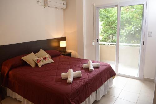 a bedroom with a bed with two towels on it at Apart del Convento in Salta