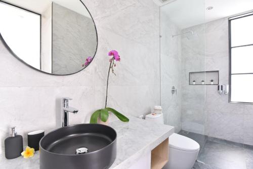 a bathroom with a black sink and a mirror at Villa Verde close to Finns Beach Club in Canggu